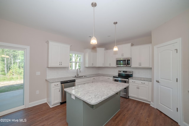 kitchen with white cabinets, stainless steel appliances, and a kitchen island