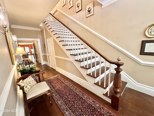 staircase with baseboards, wood finished floors, and crown molding