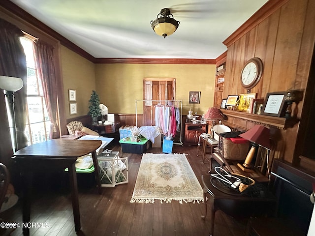 living area featuring ornamental molding and dark wood-type flooring