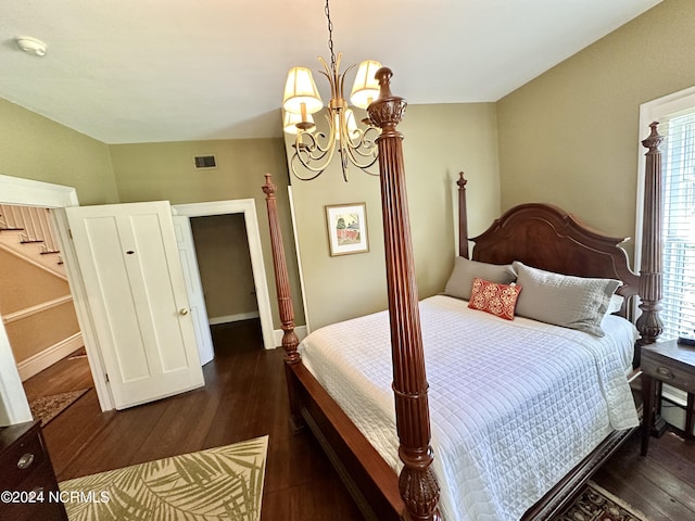 bedroom featuring visible vents, dark wood finished floors, baseboards, and an inviting chandelier