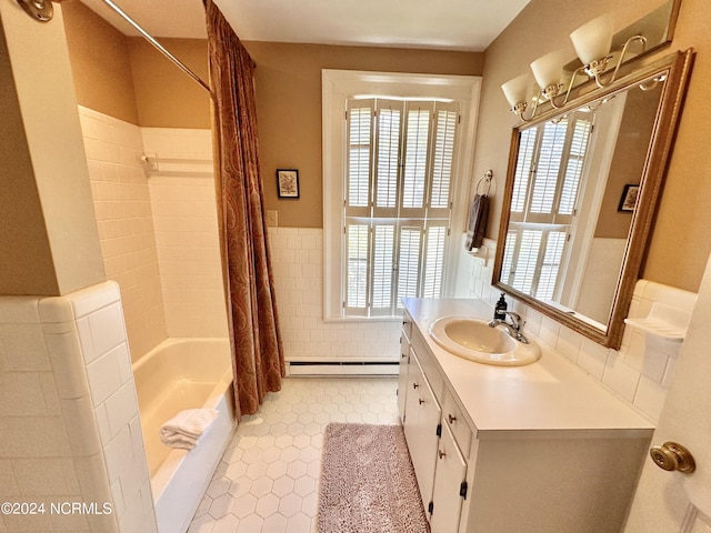 full bath featuring a wainscoted wall, vanity, tile walls, baseboard heating, and tile patterned floors