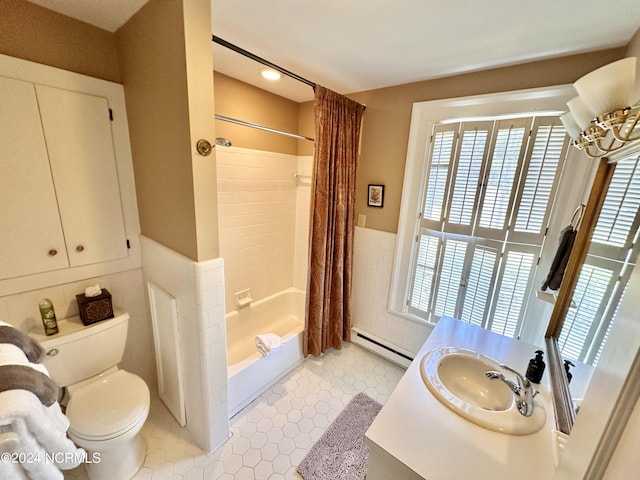 full bath featuring tile walls, a baseboard radiator, toilet, shower / bath combo, and vanity