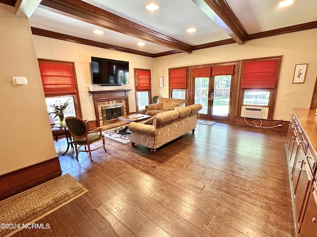 living room with ornamental molding, beamed ceiling, wood finished floors, french doors, and a fireplace