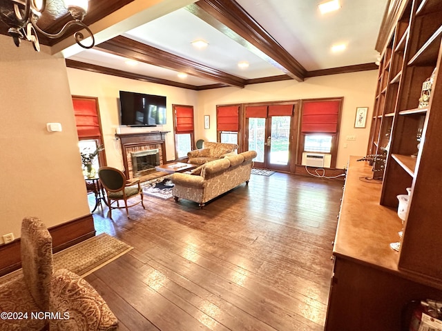 living area featuring ornamental molding, beamed ceiling, wood finished floors, french doors, and a fireplace