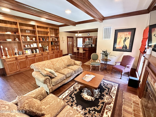 living room featuring visible vents, dark wood-type flooring, beamed ceiling, an inviting chandelier, and crown molding