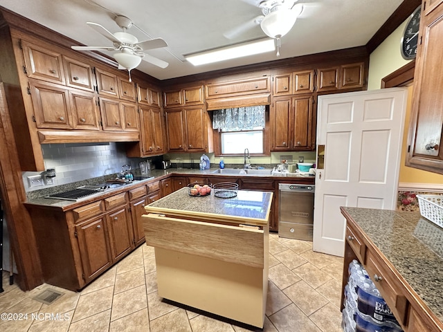 kitchen with light tile patterned floors, a kitchen island, a sink, and gas cooktop