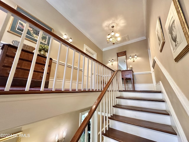 stairs with a chandelier and ornamental molding