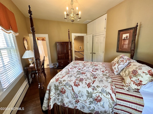 bedroom featuring dark wood-style floors, visible vents, a baseboard heating unit, and a chandelier