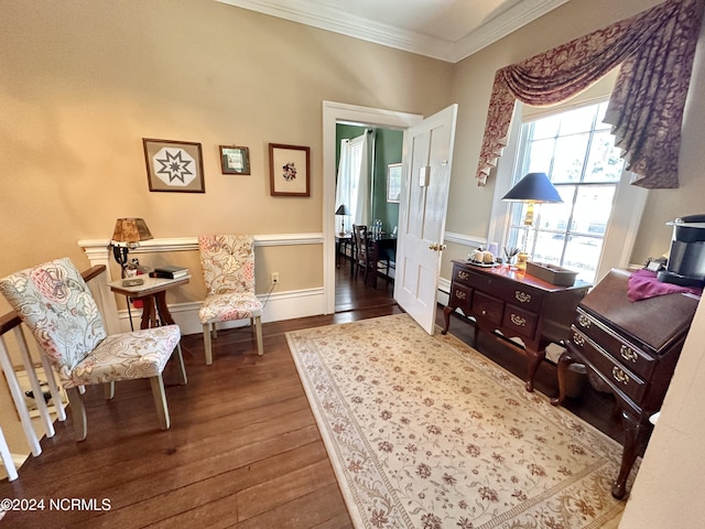 sitting room with baseboards, ornamental molding, and dark wood finished floors