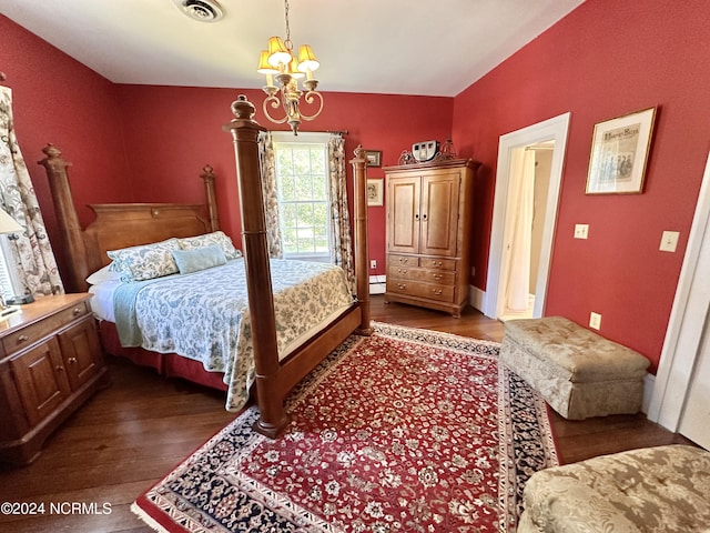 bedroom with dark wood-type flooring, a baseboard radiator, visible vents, and an inviting chandelier