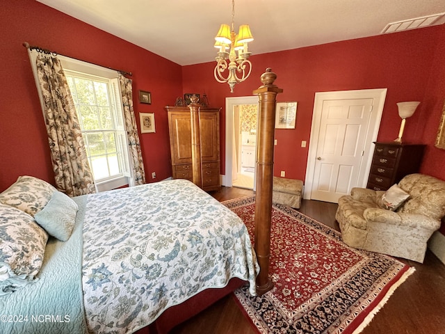 bedroom with a chandelier, visible vents, and dark wood finished floors