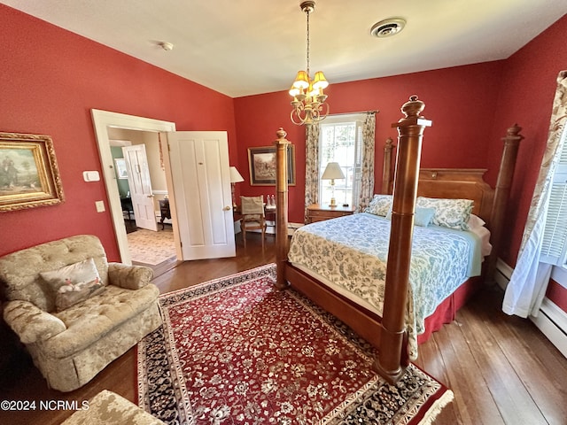 bedroom featuring vaulted ceiling, wood finished floors, visible vents, and a notable chandelier