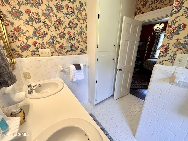 ensuite bathroom with tile patterned flooring, a wainscoted wall, connected bathroom, and wallpapered walls