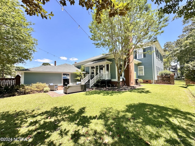 back of house featuring crawl space, a lawn, an outdoor living space, and fence