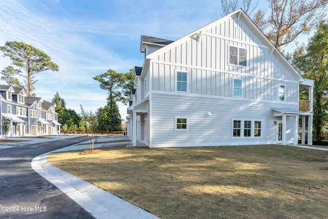 112 Seagate Pl, Wilmington, NC 28403 - view of home's exterior with board and batten siding and a lawn