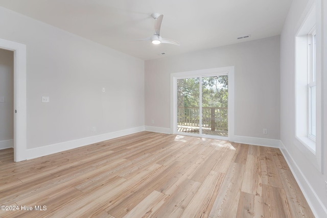 empty room with ceiling fan and light wood-type flooring