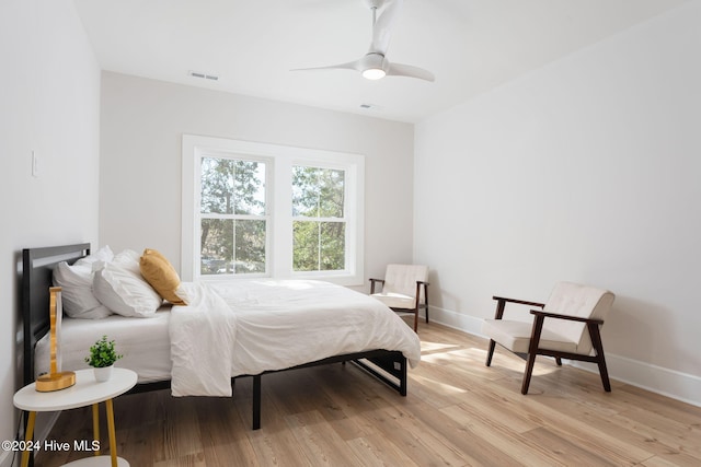 bedroom with ceiling fan and light wood-type flooring