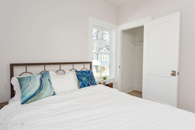 bedroom featuring wood-type flooring and a closet