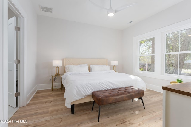 bedroom with ceiling fan and light hardwood / wood-style floors