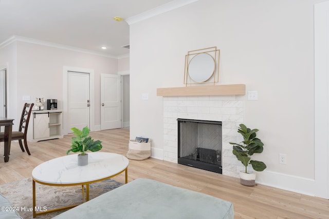 living room featuring hardwood / wood-style flooring, crown molding, and a brick fireplace