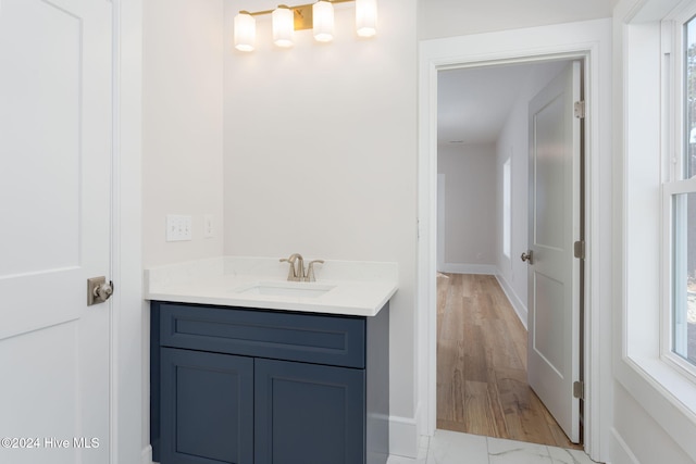 bathroom featuring hardwood / wood-style floors, vanity, and plenty of natural light