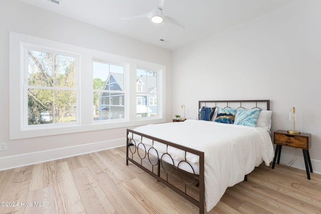 bedroom with light wood-type flooring and ceiling fan