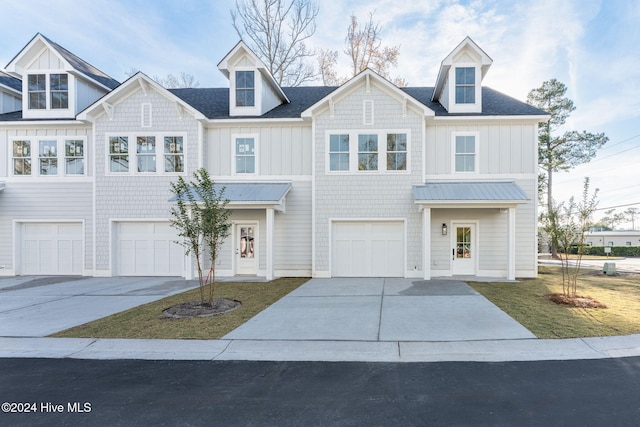 112 Seagate Pl, Wilmington, NC 28403 - view of front of house with a garage, driveway, board and batten siding, and metal roof