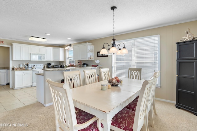 dining room with light colored carpet, an inviting chandelier, ornamental molding, and a textured ceiling