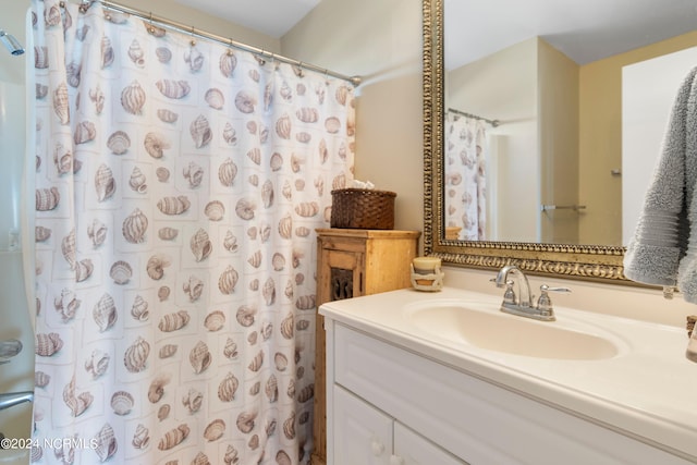 bathroom featuring walk in shower and vanity