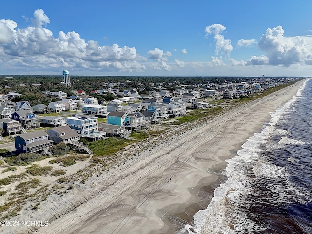 bird's eye view featuring a water view and a view of the beach