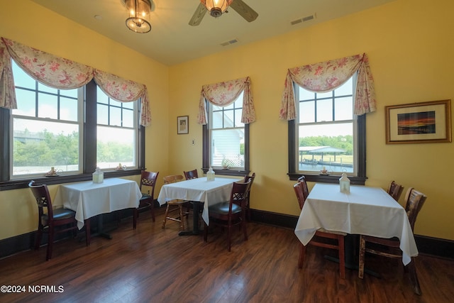 dining room with ceiling fan and dark wood-type flooring