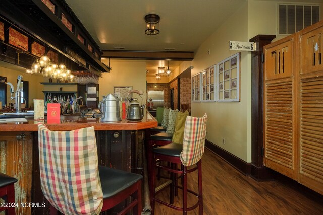 bar featuring dark wood-type flooring