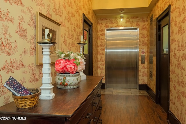 corridor featuring elevator and dark hardwood / wood-style floors