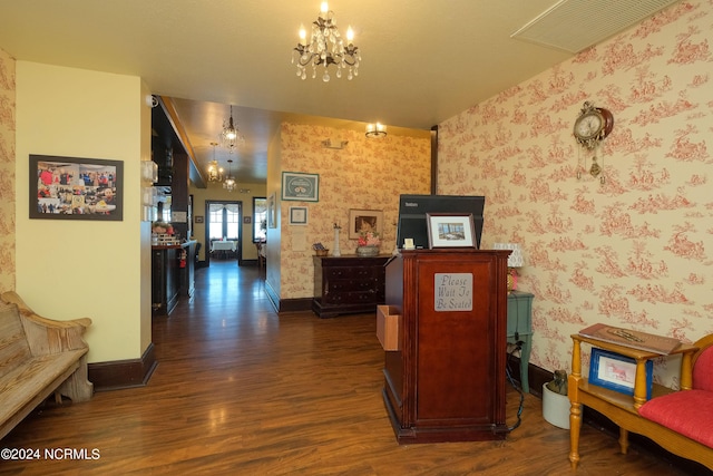 corridor featuring a chandelier and dark wood-type flooring