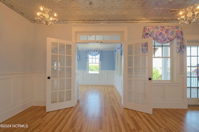 doorway to outside with french doors, hardwood / wood-style floors, and a notable chandelier