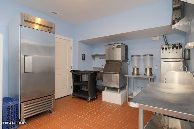 kitchen featuring tile patterned floors and stainless steel built in refrigerator