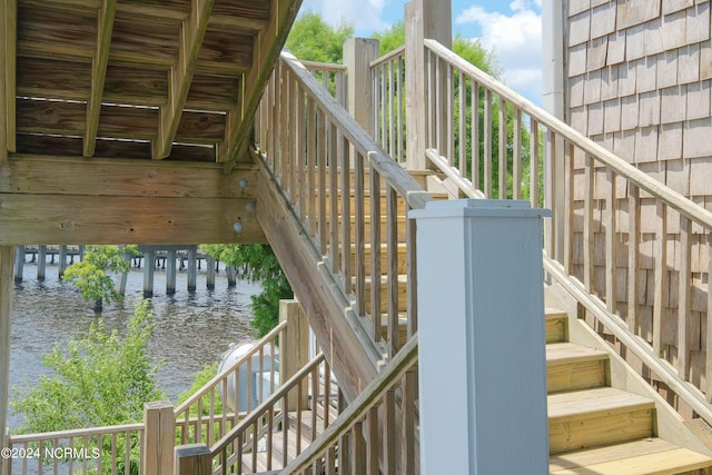 staircase with a water view