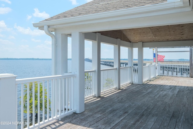 wooden terrace featuring a water view