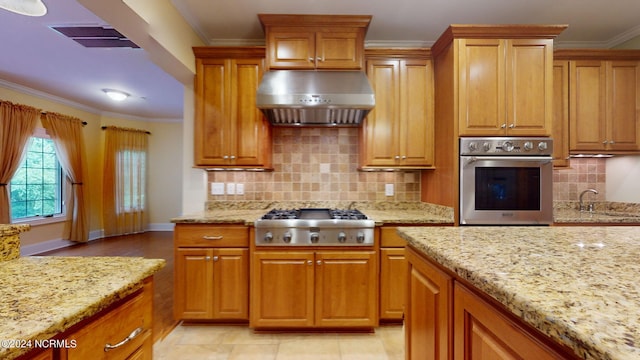 kitchen with light stone countertops, stainless steel appliances, crown molding, and range hood