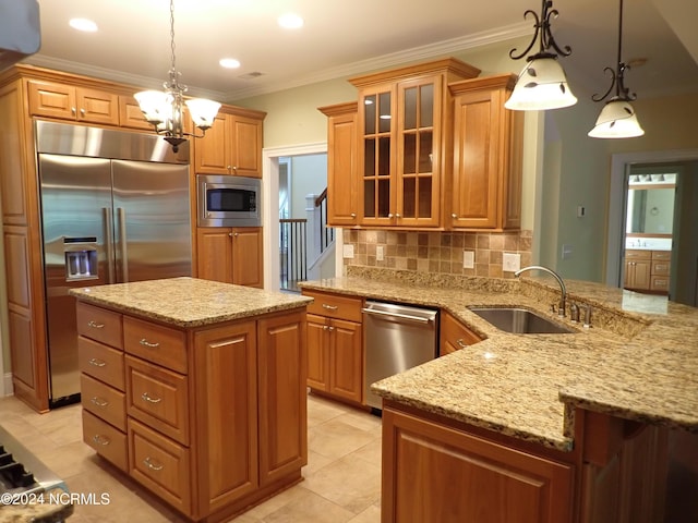 kitchen featuring sink, backsplash, built in appliances, crown molding, and pendant lighting