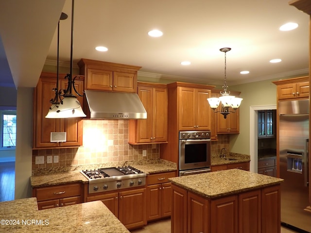 kitchen with light stone countertops, a kitchen island, hanging light fixtures, and appliances with stainless steel finishes