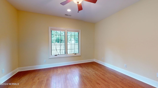 spare room with light hardwood / wood-style flooring and ceiling fan