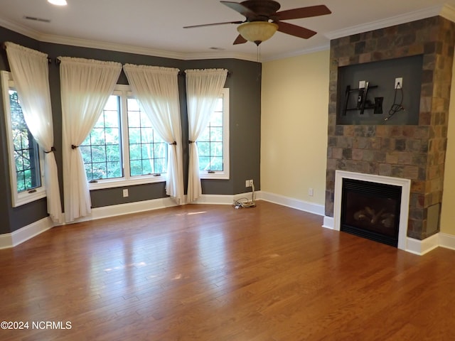 unfurnished living room with a fireplace, ceiling fan, hardwood / wood-style floors, and ornamental molding