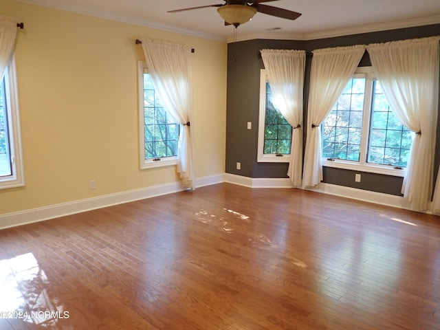 spare room featuring hardwood / wood-style flooring, ceiling fan, and crown molding