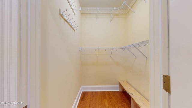 walk in closet with wood-type flooring