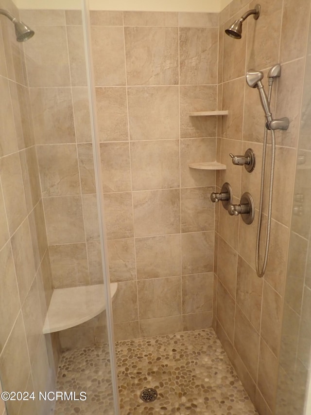 bathroom with tiled shower