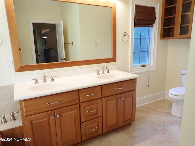 bathroom featuring tile patterned flooring, vanity, and toilet