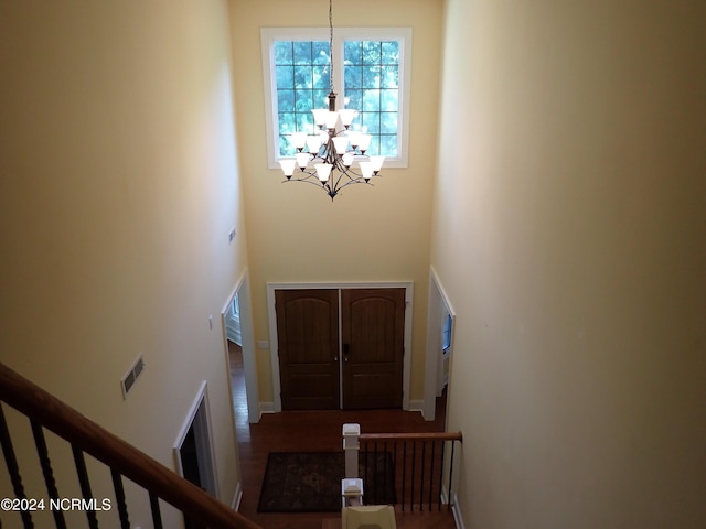 foyer entrance with a towering ceiling and an inviting chandelier