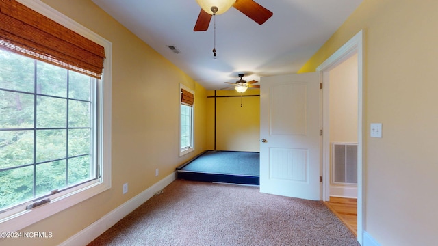 unfurnished bedroom featuring light carpet and ceiling fan