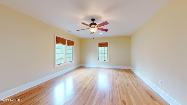 unfurnished room with ceiling fan and light hardwood / wood-style floors